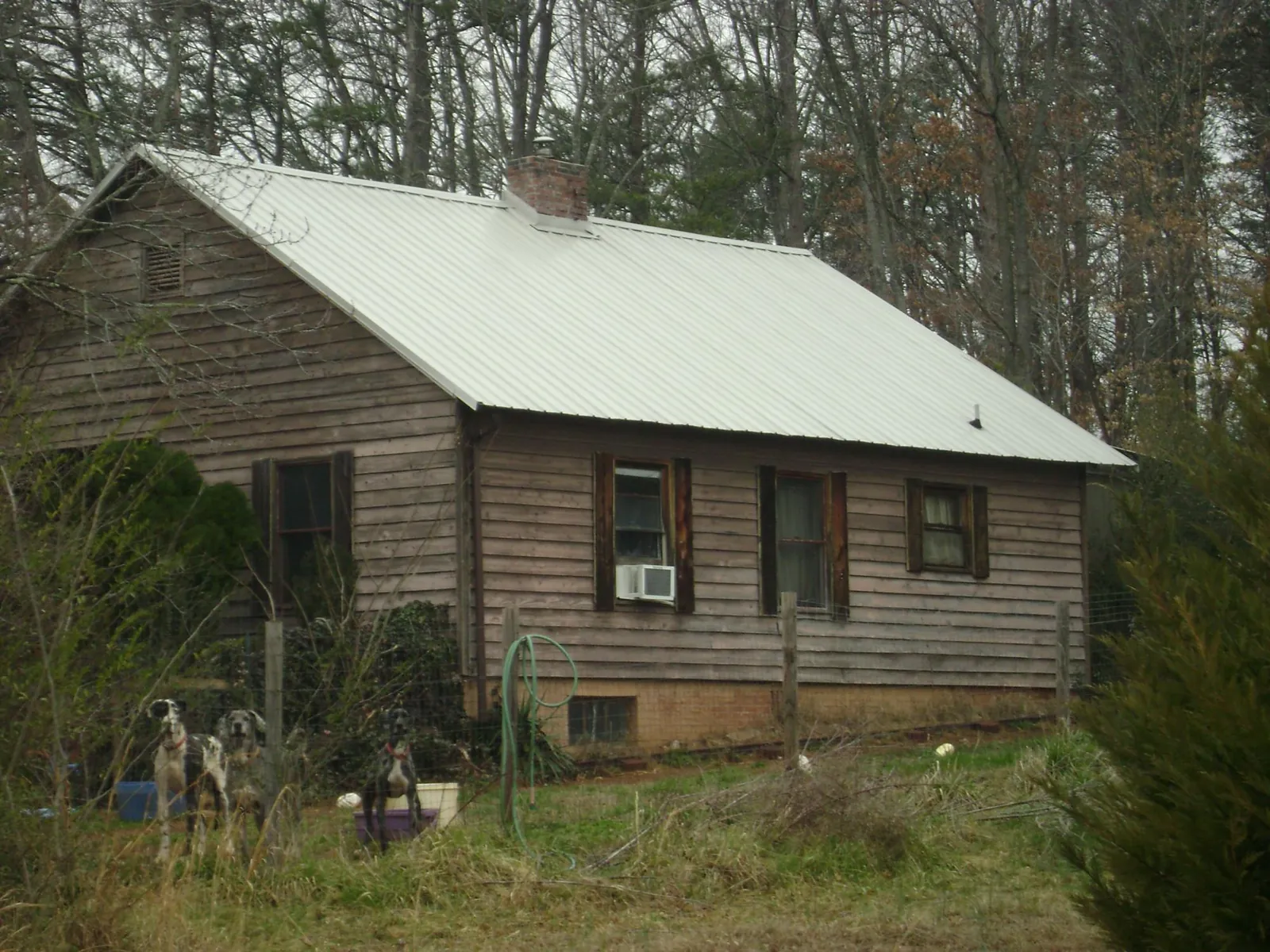 White metal roof on an old wood sided farmhouse, from a Asphalt Shingle Roof Repair job in Patuxent River
